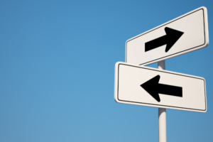 Two signs showing arrows pointing in opposite directions